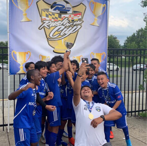 Youth soccer team in blue celebrating trophy