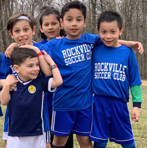 Smiling boys in blue Rockville soccer jerseys