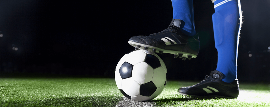 Soccer player controlling ball with cleats