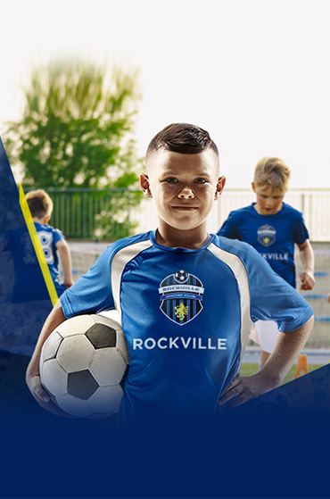 Boy holding soccer ball in Rockville jersey