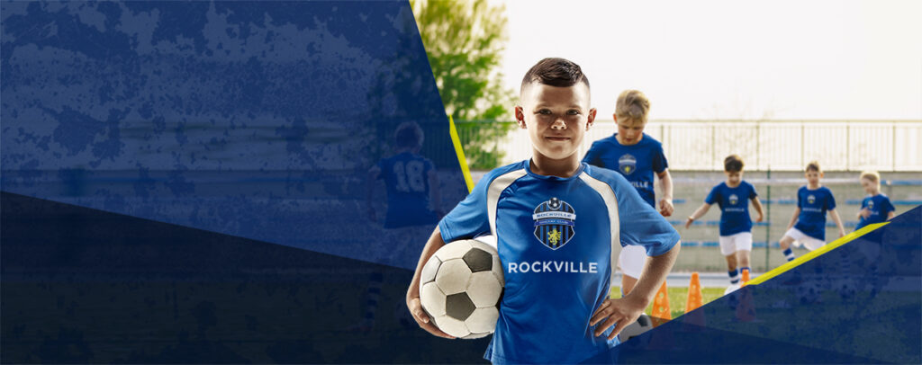 Youth soccer player holding ball, teammates behind
