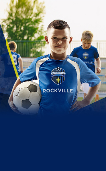 Boy in blue soccer jersey holding ball