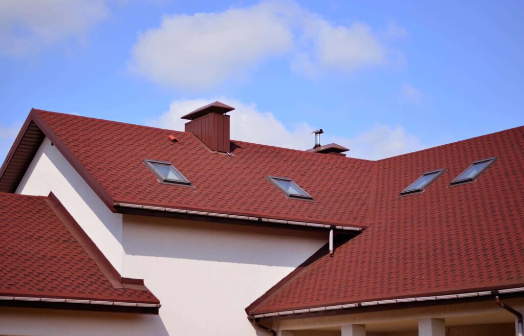 Red tiled roof with skylights and chimney