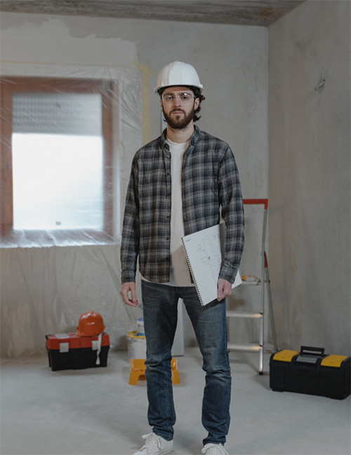 Contractor with clipboard in unfinished room